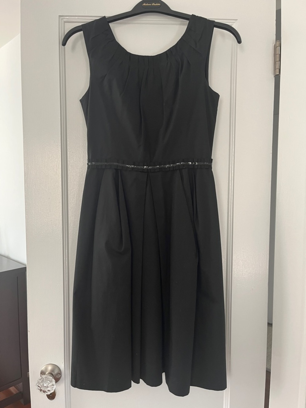 Black Sleeveless Dress with Embellished Waistline and Pleated Skirt